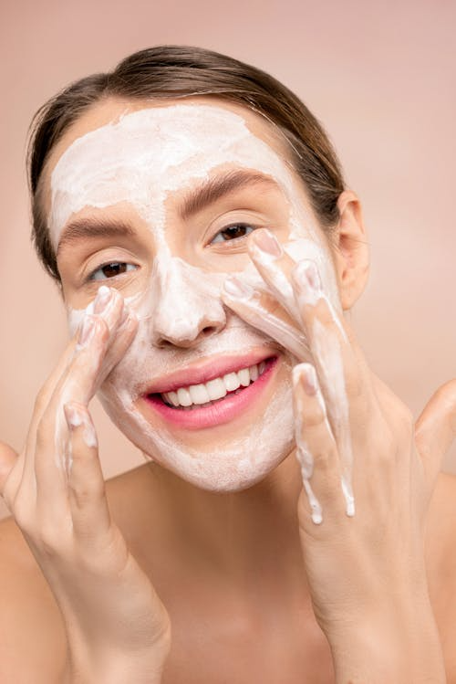 Best anti-aging skincare routine at home cleansing step – woman washing face for youthful skin